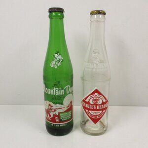 2 Vintage Soda Pop Bottles Mountain Dew It'll Tickle10 oz & Bull's Heads 10.6 oz